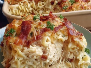 Creamy Bacon Ranch Chicken Alfredo Casserole topped with crispy bacon
