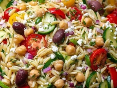 Colorful Greek Orzo Salad with fresh vegetables and feta cheese