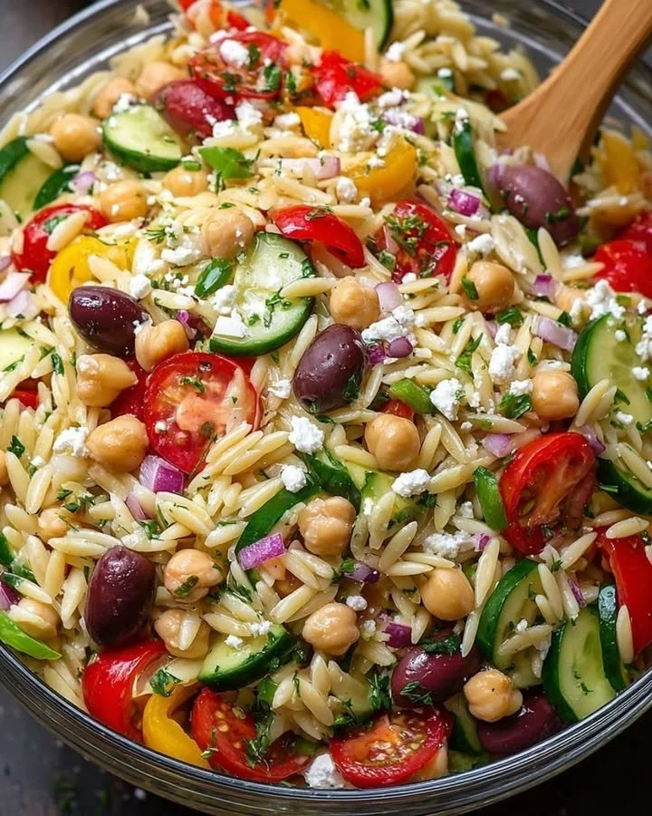 Colorful Greek Orzo Salad with fresh vegetables and feta cheese