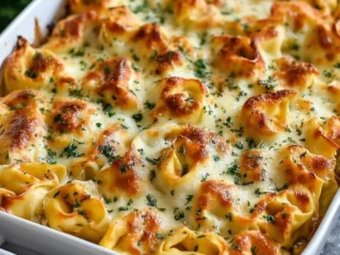 Delicious Million Dollar Baked Tortellini Casserole topped with cheese