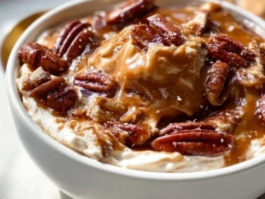 Bourbon Pecan Pie Dip served in a vibrant dish with pecans and caramel drizzle