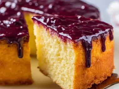Yellow cake with a vibrant berry glaze topping
