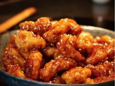 Delicious homemade Honey Sesame Chicken served with vegetables and rice