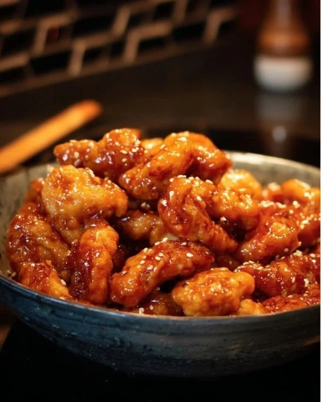 Delicious homemade Honey Sesame Chicken served with vegetables and rice