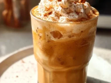 Iced Pumpkin Spice Latte topped with whipped cream and cinnamon