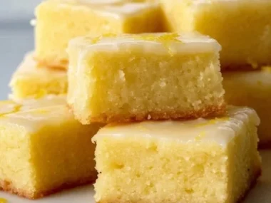 Delicious homemade lemon brownies on a plate, ready to enjoy.