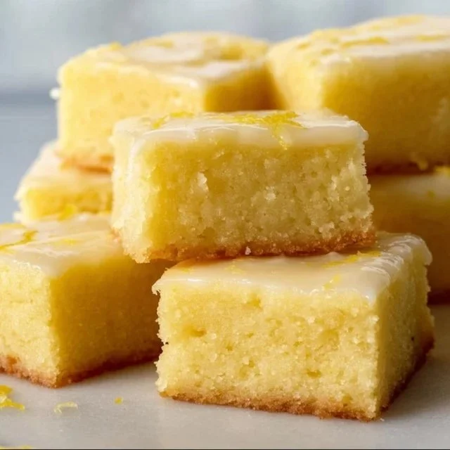 Delicious homemade lemon brownies on a plate, ready to enjoy.