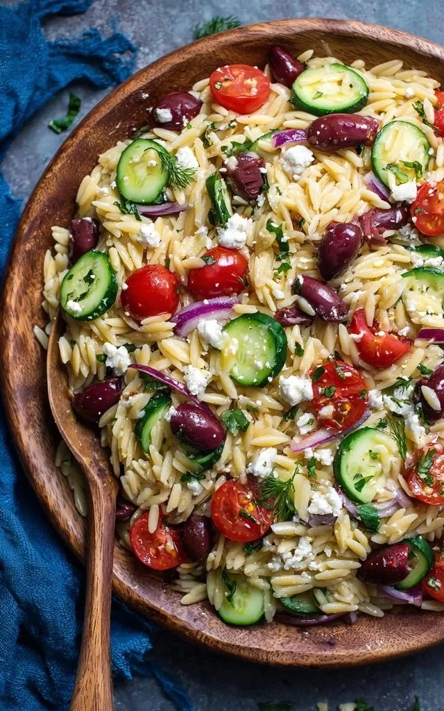 Mediterranean orzo salad with colorful vegetables and herbs