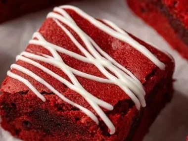 Delicious Red Velvet Brownies with cream cheese frosting on a white plate