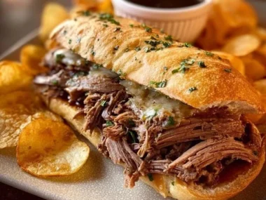 Savory roasted French dip sandwich with tender beef and au jus on a rustic bun.