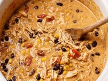 Bowl of creamy white chicken chili with cream cheese, garnished with cilantro