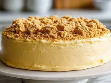 A homemade 3-Ingredient Dog Cake on a plate with dog treats beside it.