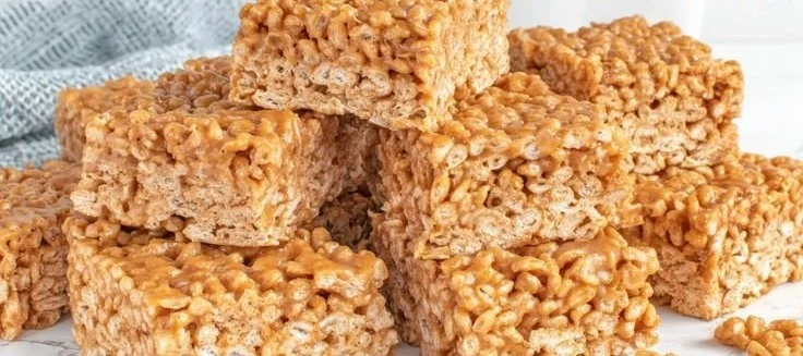 Homemade Rice Krispie Treats for dogs in a bowl with dog-friendly ingredients
