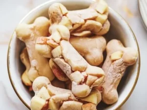 Frozen chicken broth and apple snacks on a wooden table