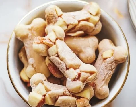Frozen chicken broth and apple snacks on a wooden table