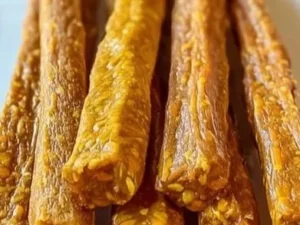 Homemade carrot and pumpkin snack sticks on a plate, perfect for healthy snacks