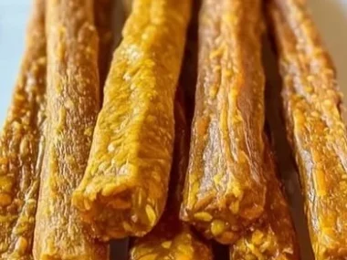Homemade carrot and pumpkin snack sticks on a plate, perfect for healthy snacks