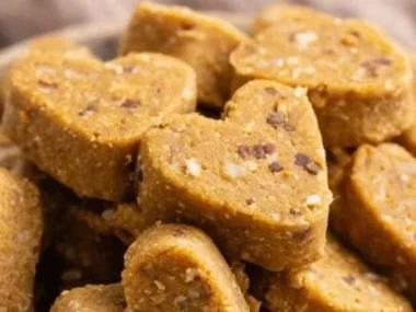 Homemade chicken broth dog biscuits on a wooden surface