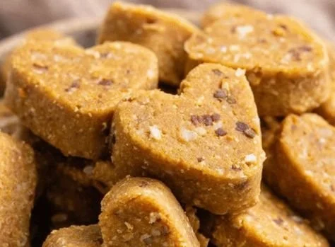 Homemade chicken broth dog biscuits on a wooden surface