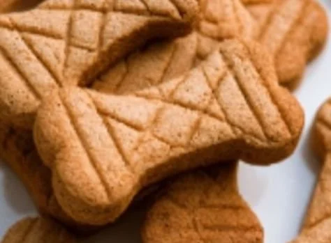 Homemade peanut butter dog treats on a wooden surface