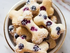 Homemade no-bake blueberry coconut dog treats on a wooden surface