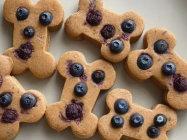 Homemade peanut butter blueberry dog treats on a wooden table