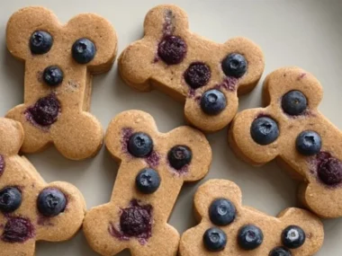 Homemade peanut butter blueberry dog treats on a wooden table