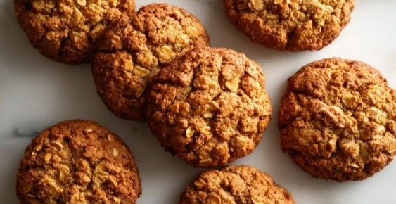 Homemade pumpkin oat cookies for dogs on a wooden table