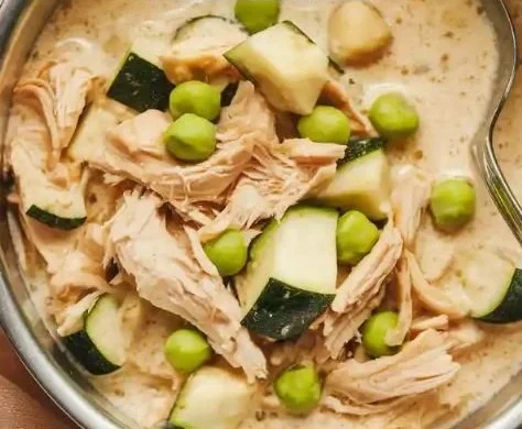 Homemade chicken, zucchini, and sweet peas dog stew in a bowl
