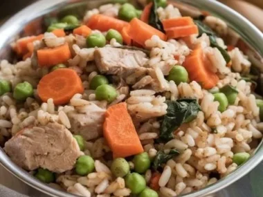 A bowl of homemade dog food with vegetables and meat for healthy pets