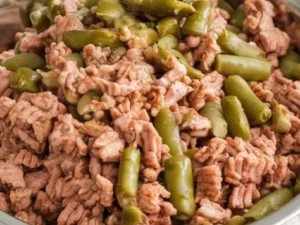 A bowl of lean turkey and green beans, a healthy meal option for dogs.
