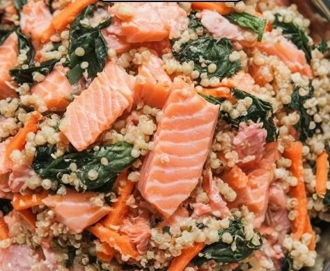 Salmon and quinoa power bowl with veggies and dressing