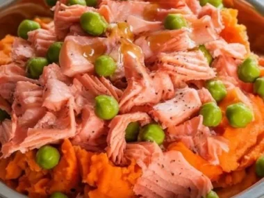 A bag of Salmon and Sweet Potato dog food with a healthy dog in the background