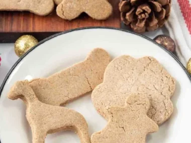 Homemade gingerbread dog treats on a plate for festive pet enjoyment