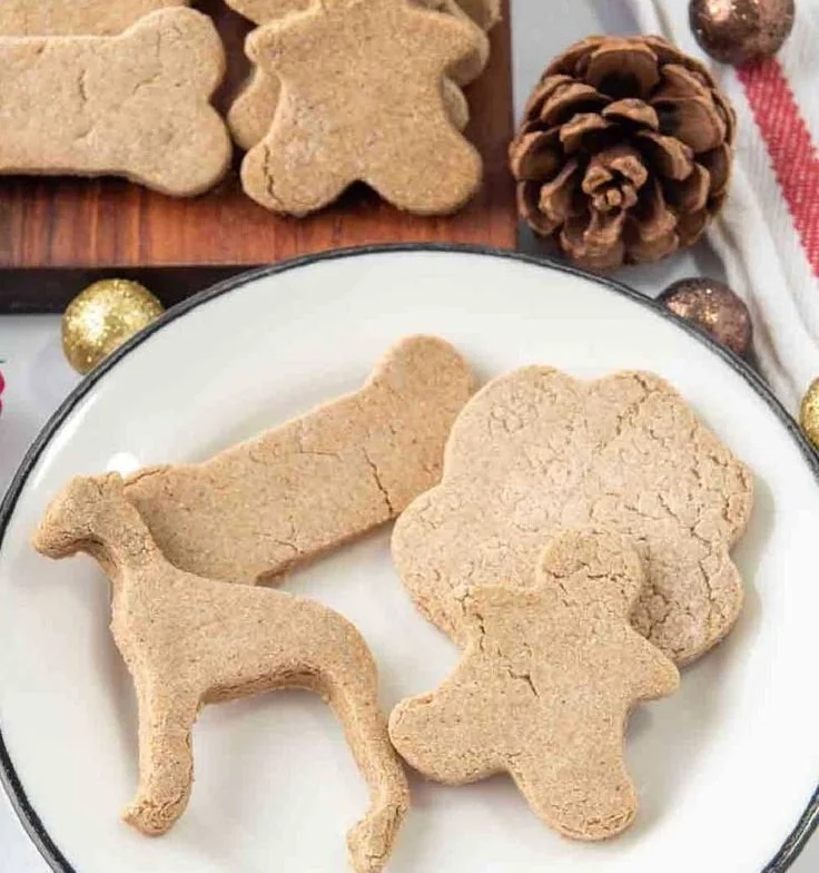 Homemade gingerbread dog treats on a plate for festive pet enjoyment