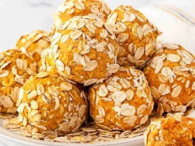 Delicious no-bake pumpkin peanut butter balls for dogs on a rustic table