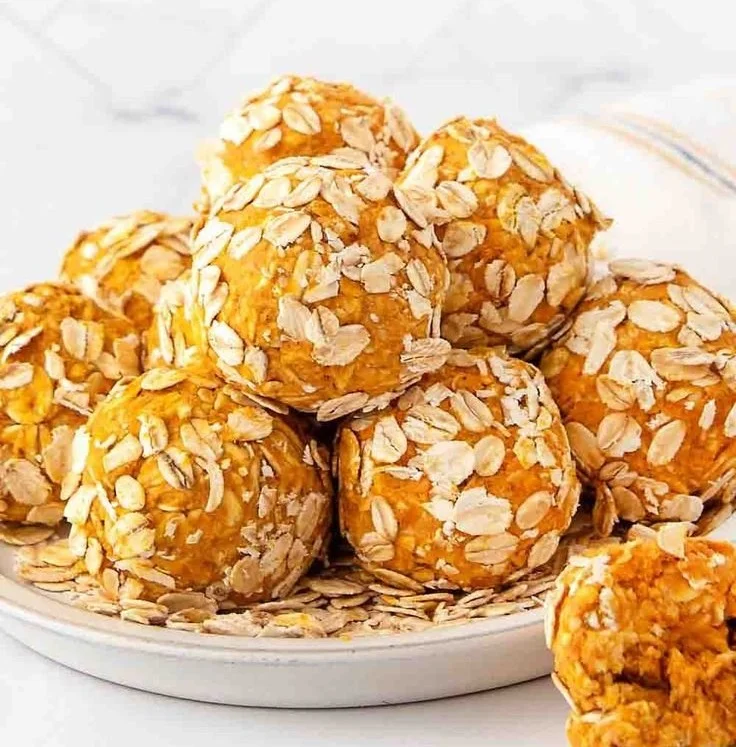 Delicious no-bake pumpkin peanut butter balls for dogs on a rustic table