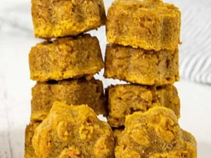 Homemade peanut butter pumpkin dog treats on a wooden table