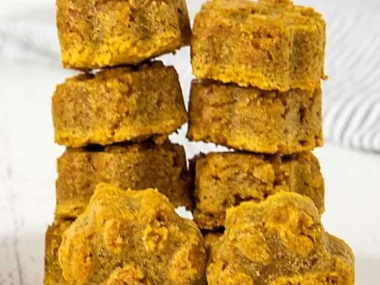 Homemade peanut butter pumpkin dog treats on a wooden table