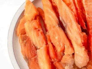 Salmon jerky treats for dogs in a bowl, healthy pet snack