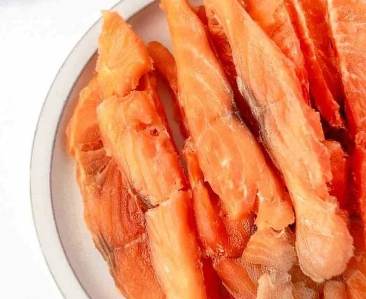 Salmon jerky treats for dogs in a bowl, healthy pet snack