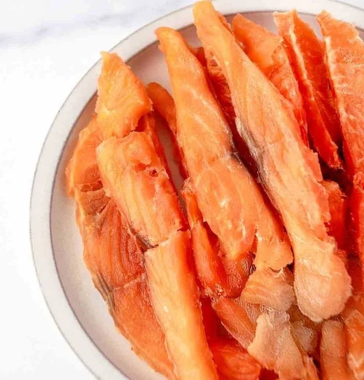 Salmon jerky treats for dogs in a bowl, healthy pet snack
